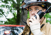 Firefighter speaking into a walkie talkie