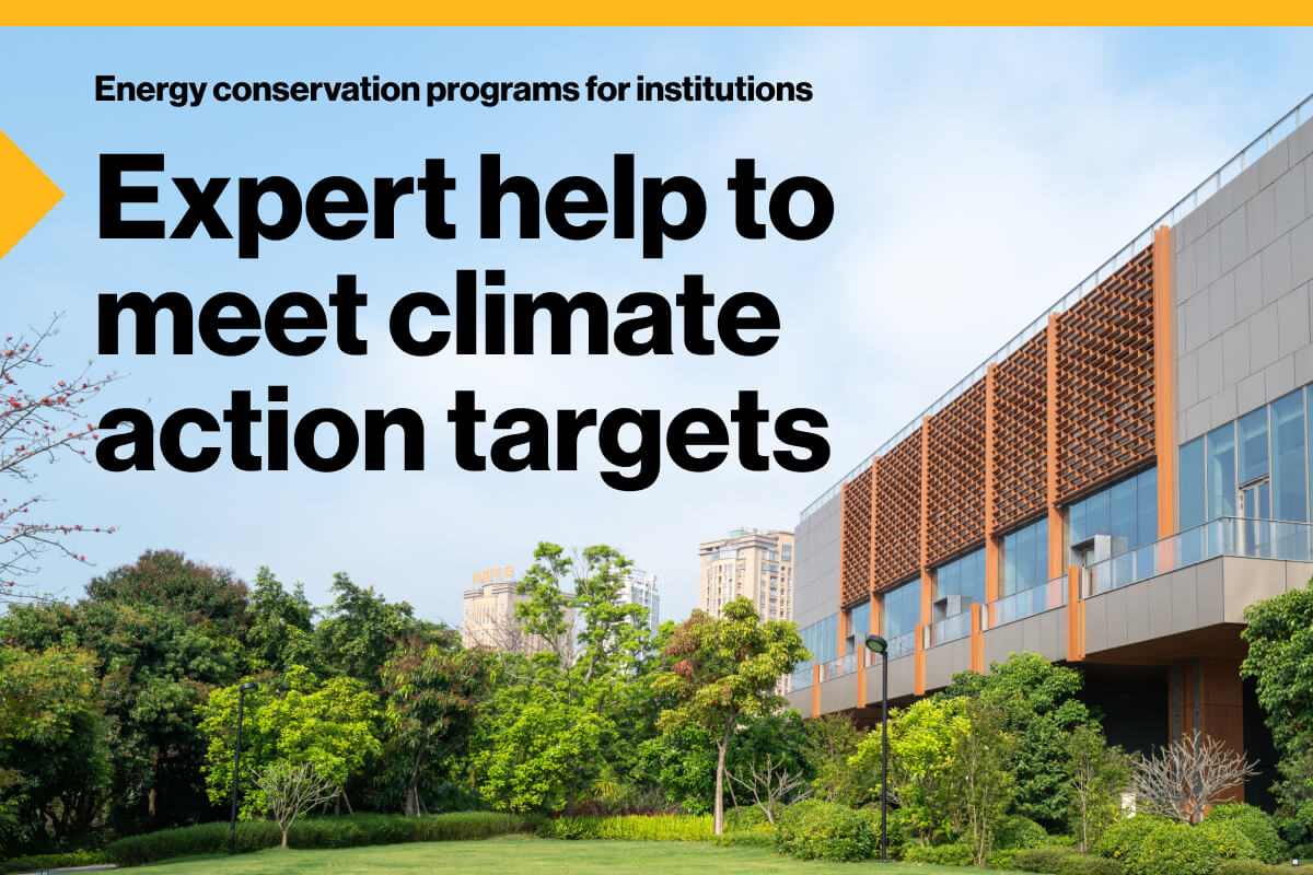 Energy conservation programs for institutions. Expert help to meet climate action targets: An image of the exterior of an institutional building, with greenery surrounding it.