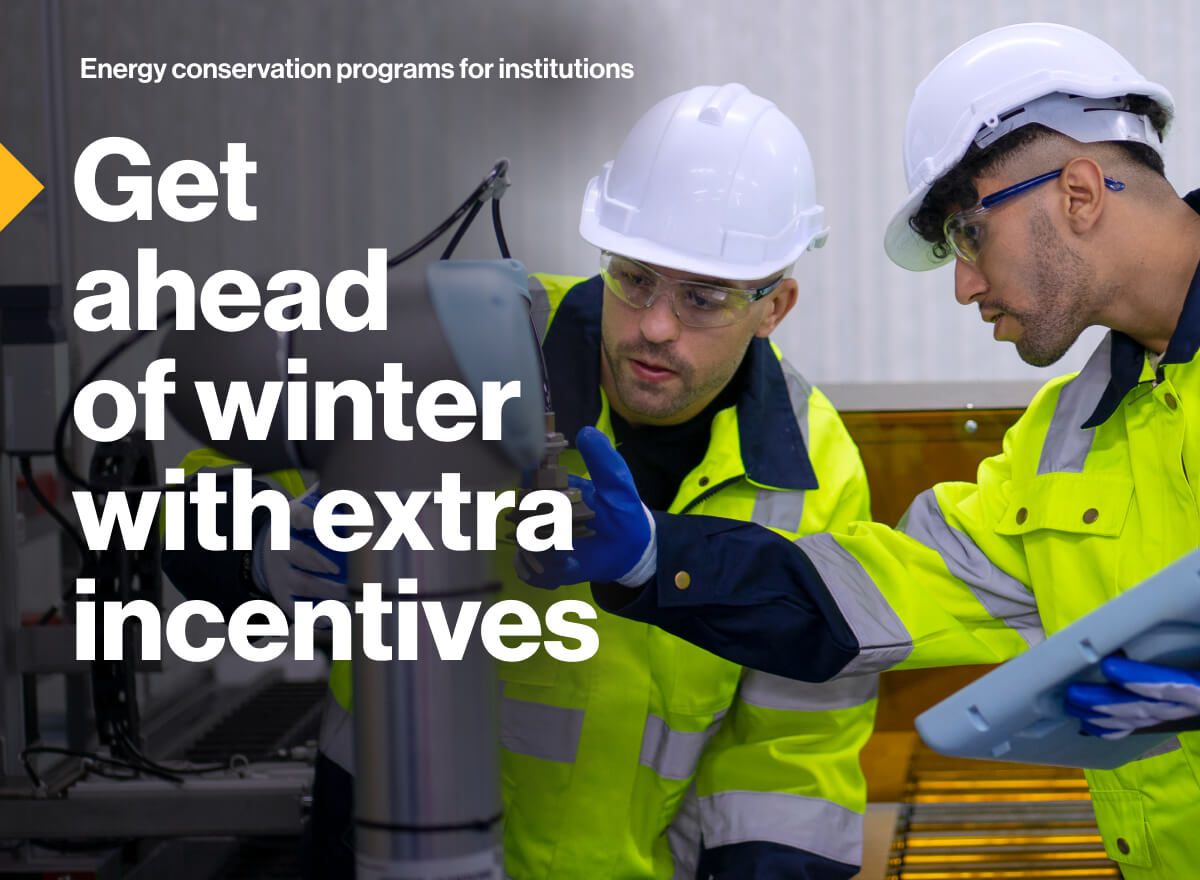 Energy conservation programs for institutions. Get ahead of winter with extra incentives: Image of two engineers examining and making adjustments to a steam system.