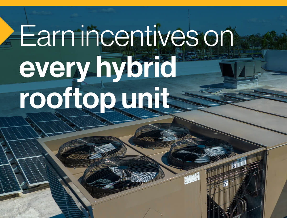 Earn incentives on every hybrid rooftop unit: Image of a hybrid rooftop unit on the roof of a building. Part of the roof is also lined with solar panels.